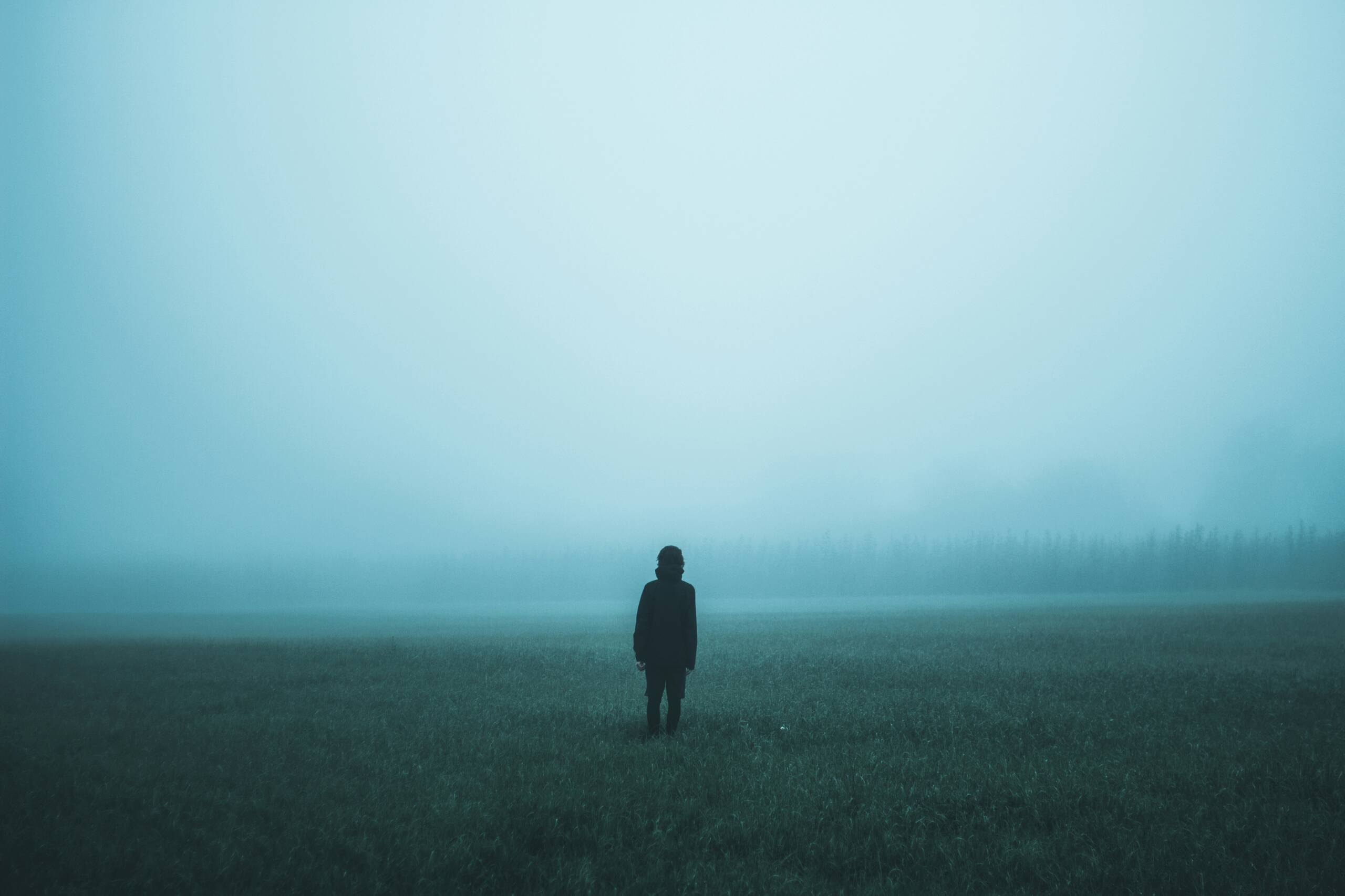 Person standing in the mist representing a phase of transformation