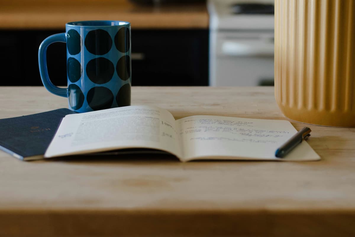 image of a journal and a cup of coffee to journal for productivity