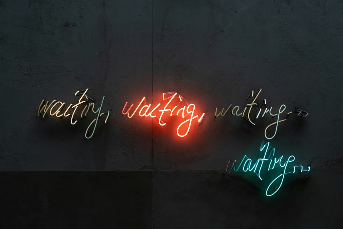 neon sign stop waiting (for everything in life to be perfect)